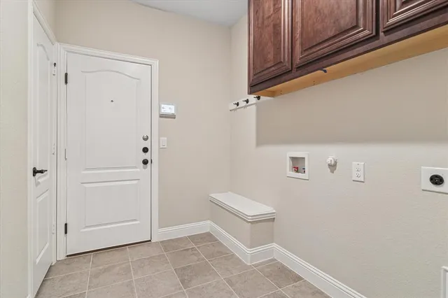 an empty room with wooden floor closet and windows