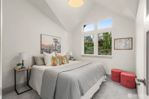 a bedroom with a bed and a painting on the wall