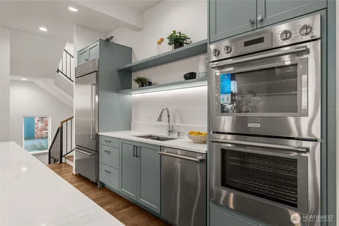 a kitchen with stainless steel appliances granite countertop a stove and a sink