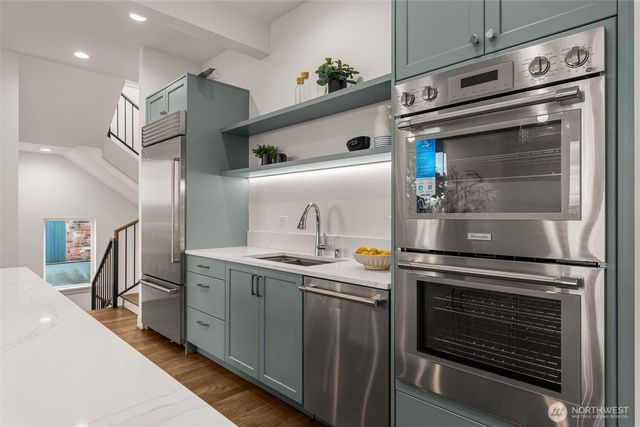 a kitchen with stainless steel appliances granite countertop a stove and a sink