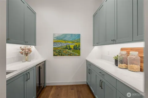 a utility room with cabinets washer and dryer