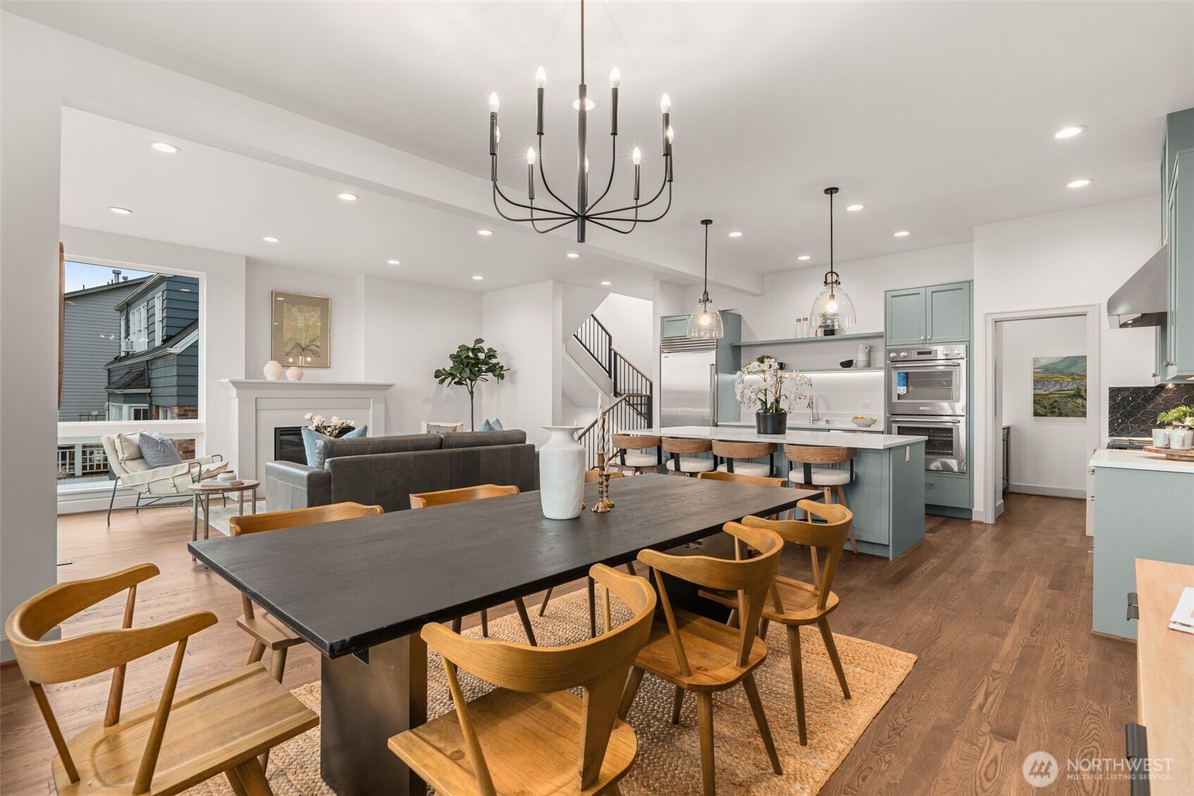 6032 50th Avenue Northeast Seattle, WA 98115 - Photo 9 of 40 a view of a dining room with furniture a kitchen and chandelier