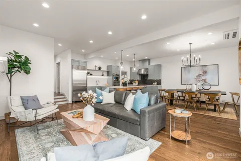 a living room with furniture kitchen and a chandelier