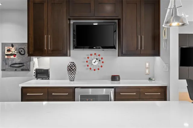 a bathroom with a sink a mirror and a microwave