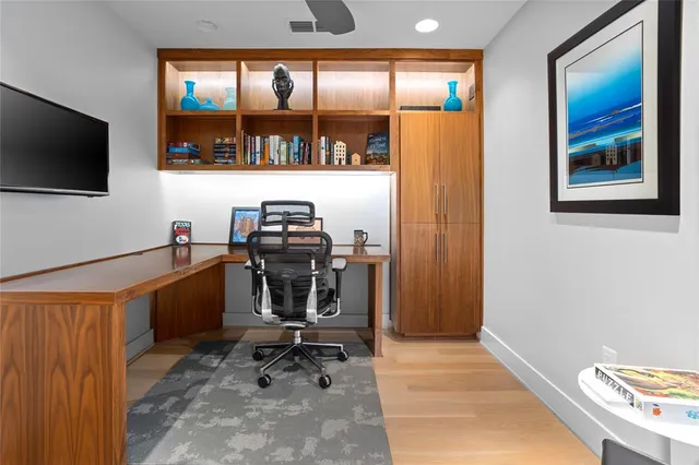 a view of a workspace with furniture and a flat screen tv