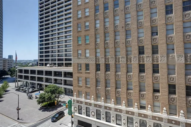 a view of building with potted plants