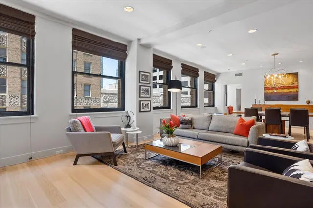 a living room with furniture a rug and a window