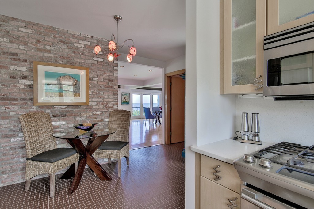 139-138 Atlantic Road Gloucester, MA 01930 - Photo 16 of 28 a view of a dining room with furniture and a chandelier