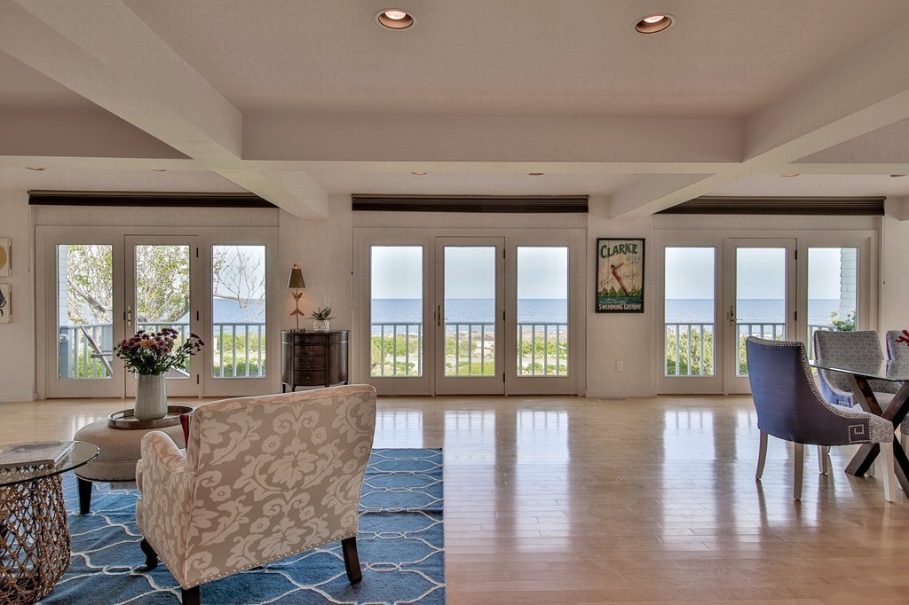 139-138 Atlantic Road Gloucester, MA 01930 - Photo 17 of 28 a living room with furniture and a large window with wooden floor