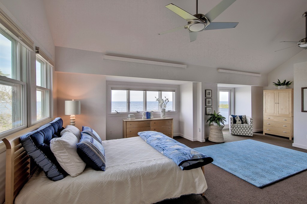 139-138 Atlantic Road Gloucester, MA 01930 - Photo 19 of 28 a bedroom with a bed and wooden floor