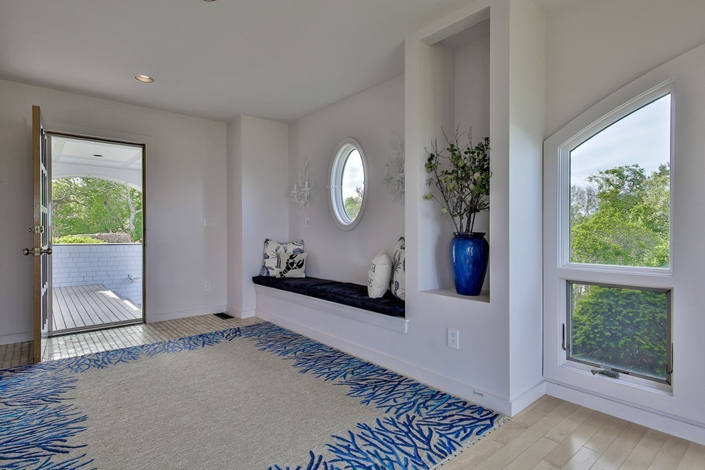 139-138 Atlantic Road Gloucester, MA 01930 - Photo 6 of 28 a view of a hallway to a livingroom with furniture and window