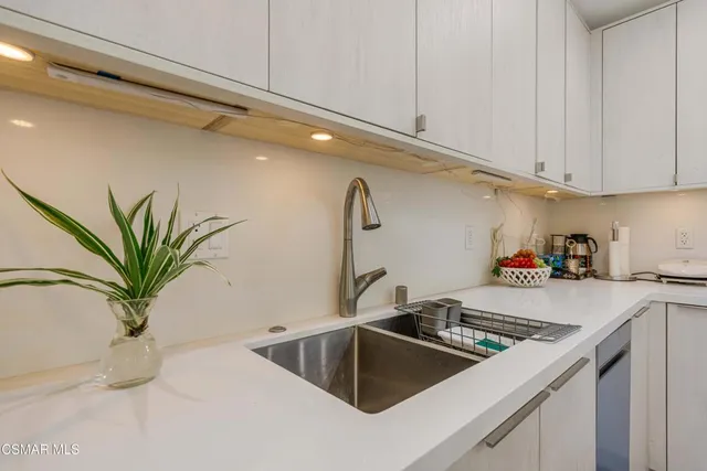 a kitchen with a sink and cabinets