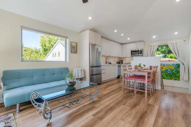 a living room with furniture and a wooden floor