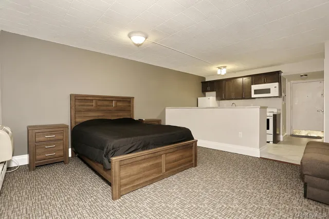 a bedroom with a bed and cabinets