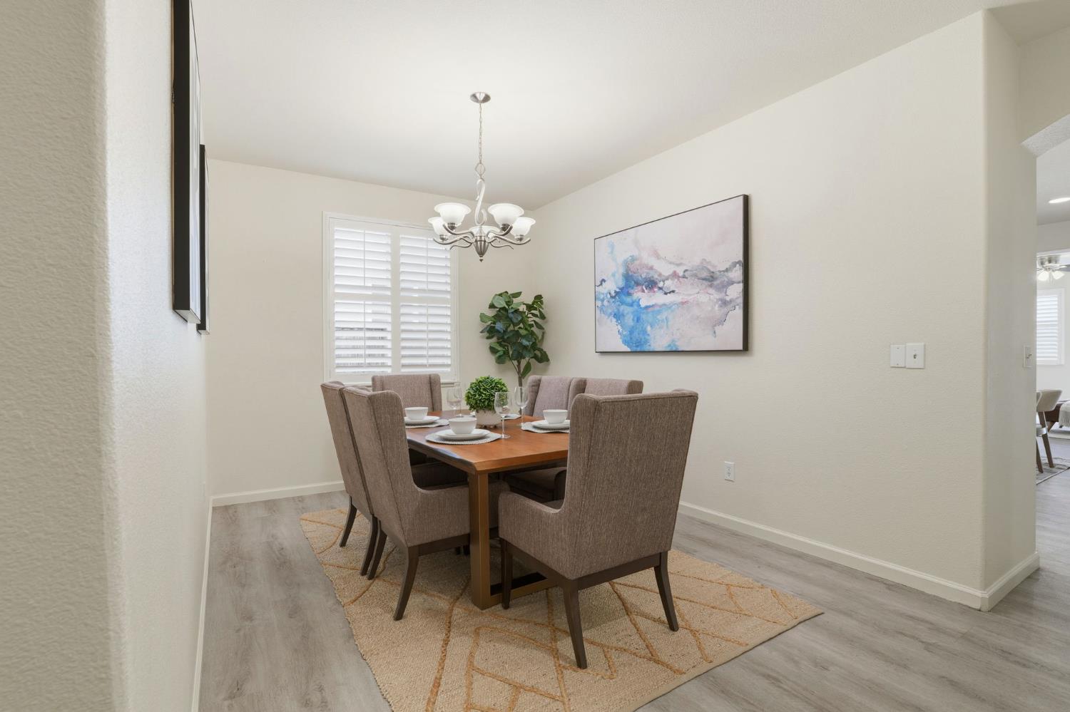 10250 Rudder Way Stockton, CA 95209 - Photo 17 of 46 a dining room with furniture a rug and a chandelier