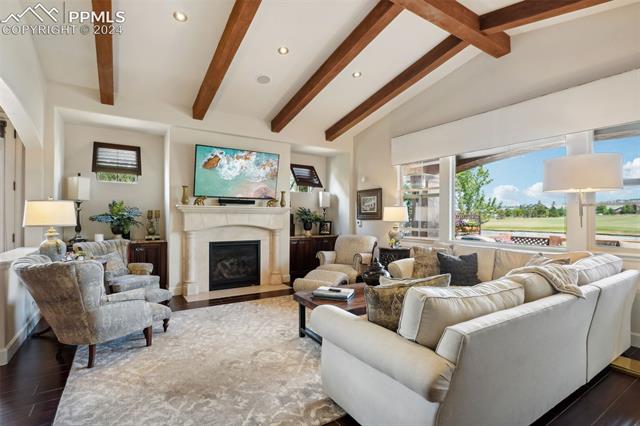 2204 Rocking Horse Court Colorado Springs, CO 80921 - Photo 4 of 50 Living room featuring a premium fireplace, lofted ceiling with beams, and dark hardwood / wood-style floors