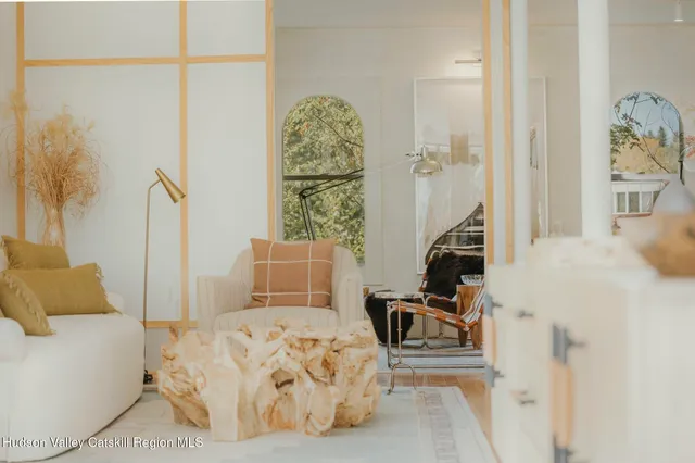 a living room with furniture and a floor to ceiling window