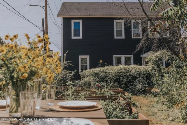 a view of a yard plants and large tree