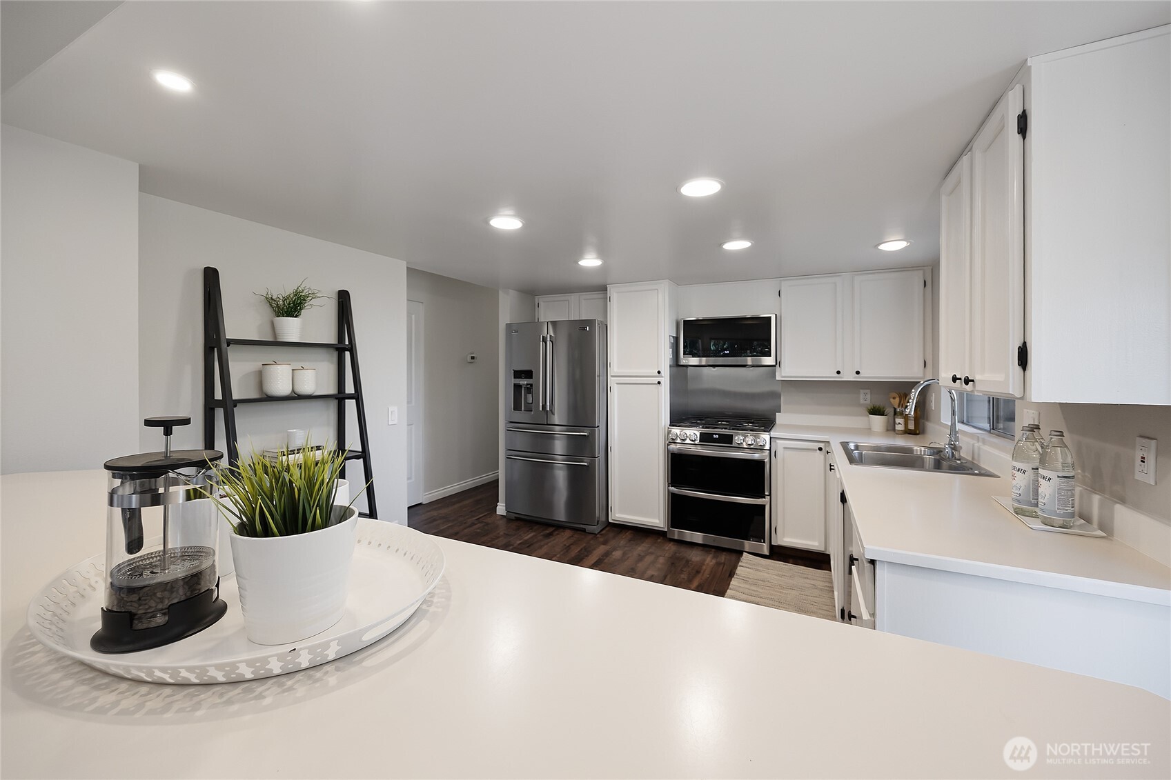 23707 Meridian Place West Bothell, WA 98021 - Photo 15 of 40 a kitchen with stainless steel appliances kitchen island granite countertop a refrigerator and a sink
