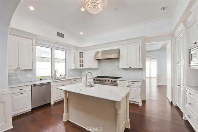 a kitchen with a stove a sink and a refrigerator
