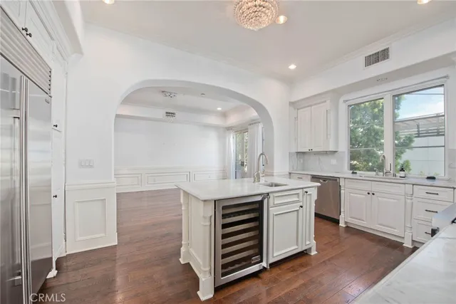 a kitchen with stainless steel appliances granite countertop a sink stove cabinets and wooden floor