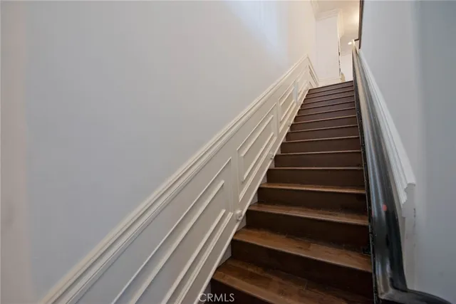 a bathroom with a granite countertop toilet sink and mirror