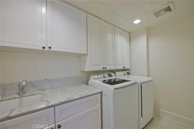 a view of a kitchen with white cabinets