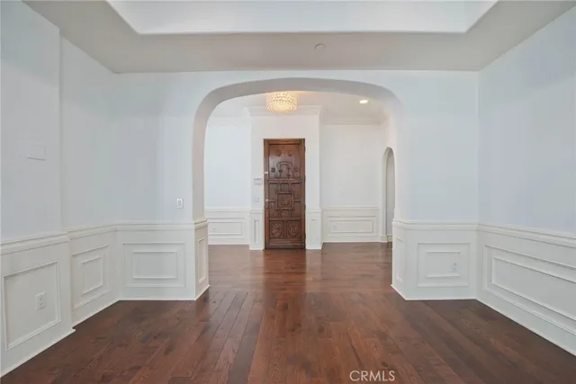 a view of a hallway with wooden floors and a fireplace