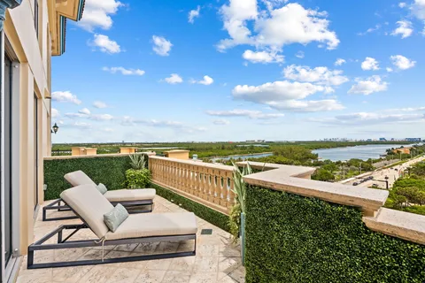 a view of a terrace with lawn chairs