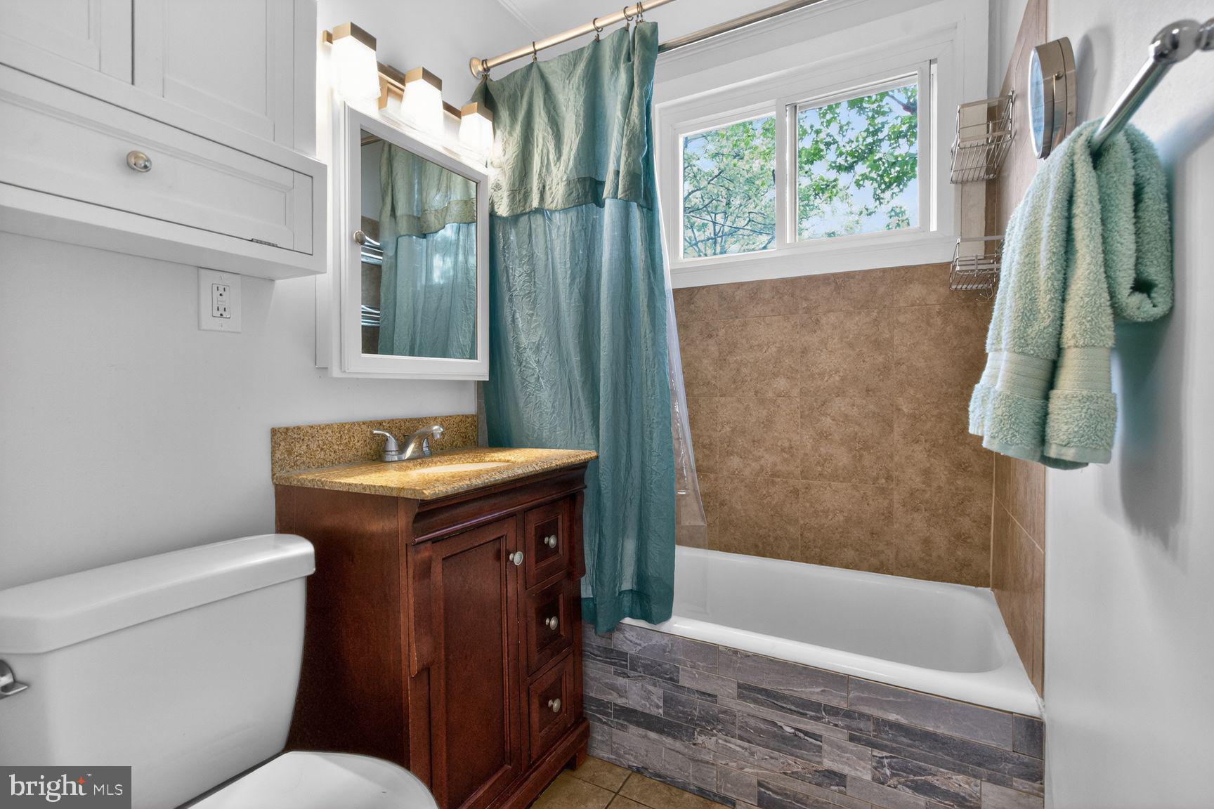 51 Ridge Road Greenbelt, MD 20770 - Photo 7 of 23 a bathroom with a sink a toilet and shower