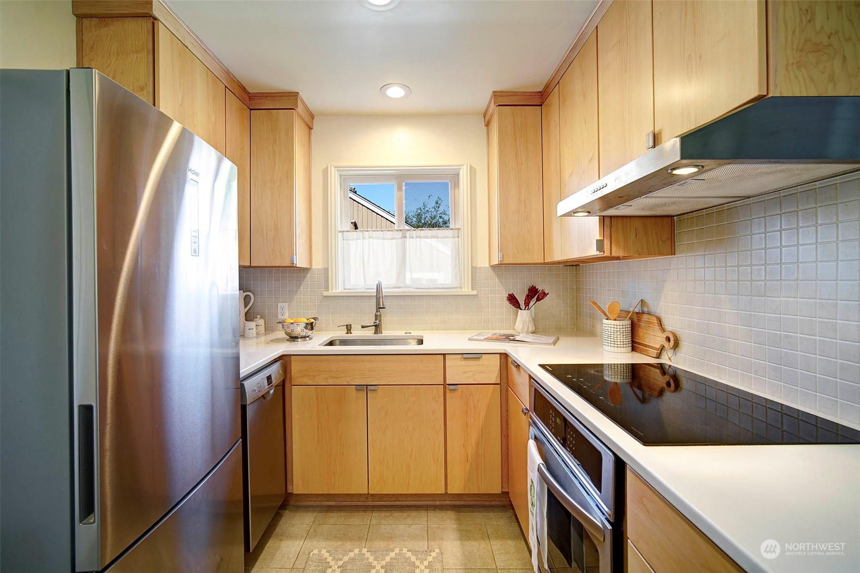 4100 Southwest Ida Street Seattle, WA 98136 - Photo 7 of 32 a kitchen with a sink a refrigerator and cabinets