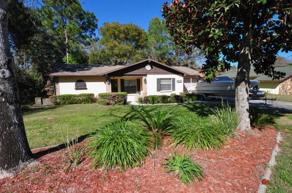 11255 Blythville Road Spring Hill, FL 34608 - Photo 1 of 1 a front view of a house with garden