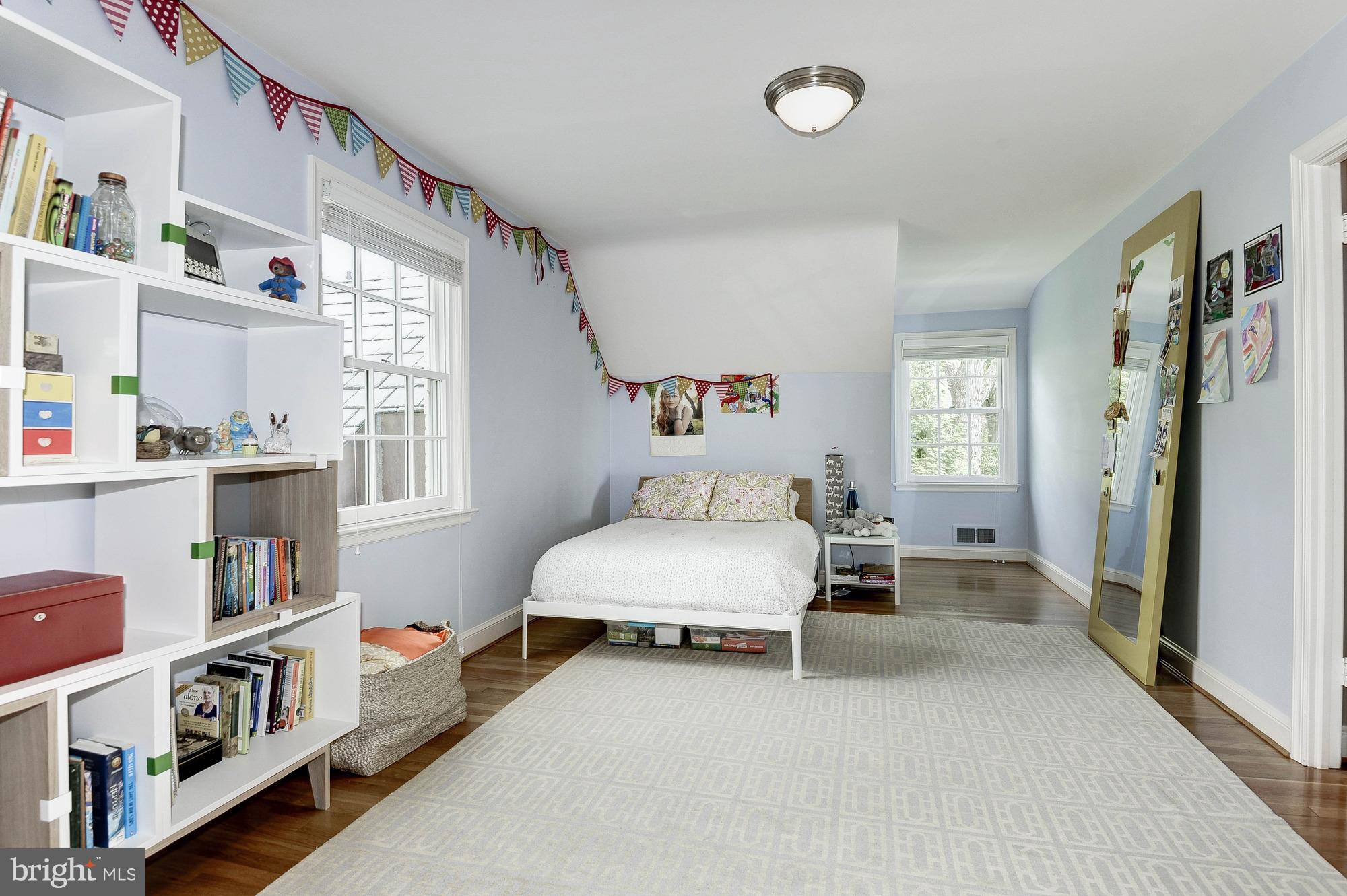 5120 Upton Street Northwest Washington, DC 20016 - Photo 12 of 22 a bedroom with furniture and a book shelf