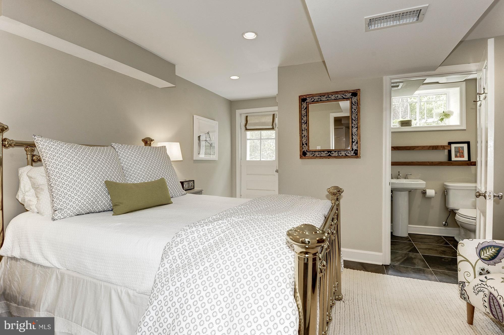 5120 Upton Street Northwest Washington, DC 20016 - Photo 15 of 22 a bedroom with a bed and a view of living room