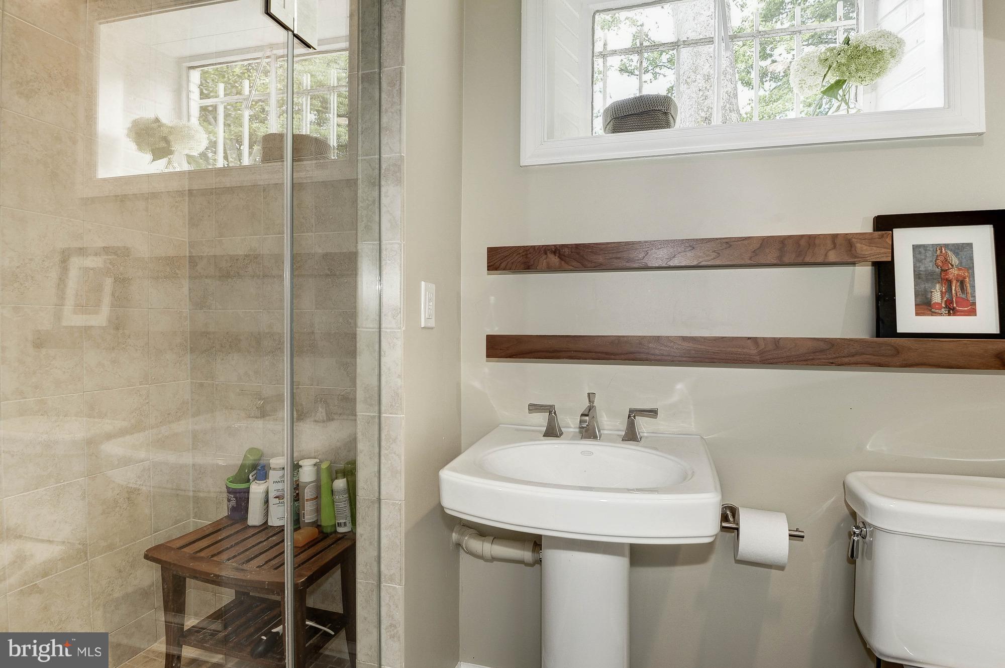5120 Upton Street Northwest Washington, DC 20016 - Photo 16 of 22 a bathroom with a sink a toilet and a mirror