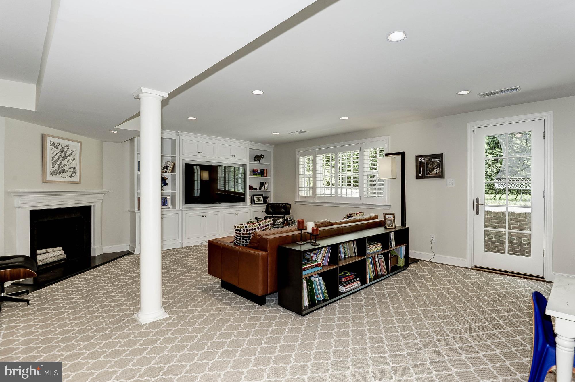 5120 Upton Street Northwest Washington, DC 20016 - Photo 18 of 22 a living room with furniture a flat screen tv and a fireplace