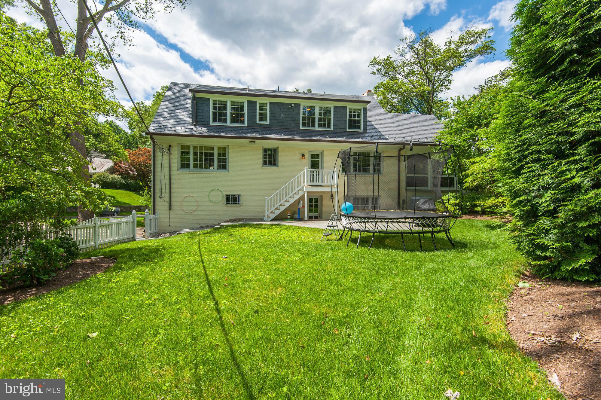 5120 Upton Street Northwest Washington, DC 20016 - Photo 21 of 22 a front view of a house with a yard