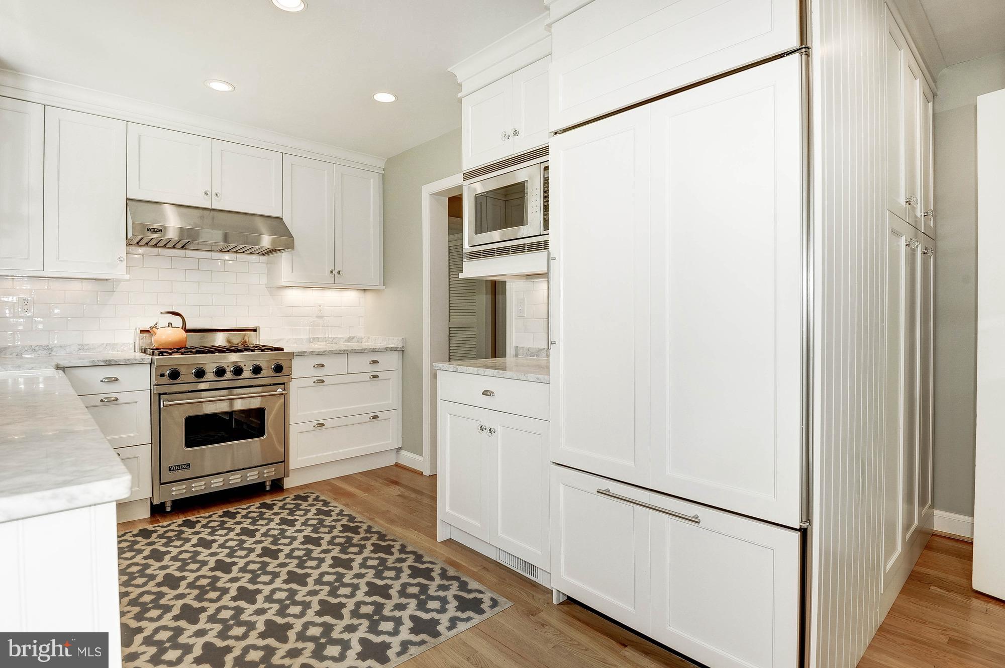 5120 Upton Street Northwest Washington, DC 20016 - Photo 6 of 22 a kitchen with stainless steel appliances a refrigerator stove and white cabinets
