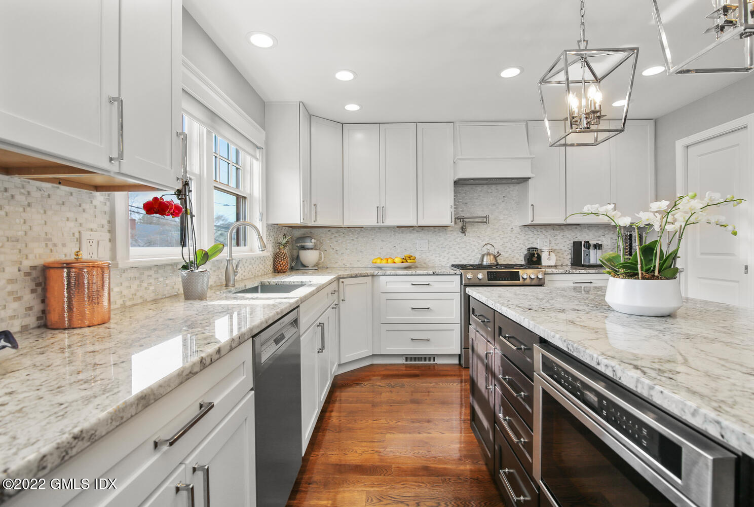 24 Harold Street, Unit C Cos Cob, CT 06807 - Photo 14 of 32 a kitchen with kitchen island granite countertop a sink a counter top space appliances and cabinets