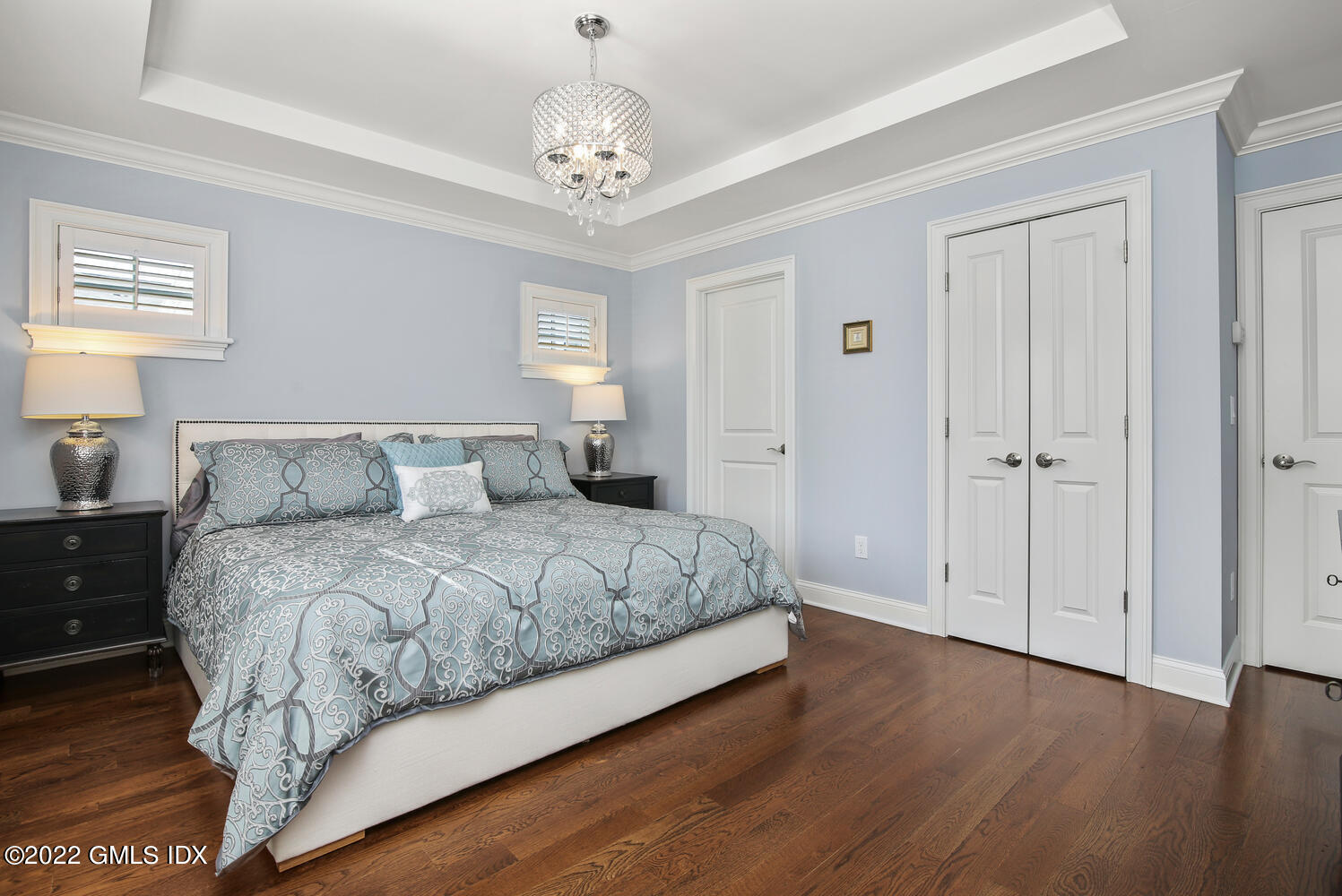 24 Harold Street, Unit C Cos Cob, CT 06807 - Photo 17 of 32 a spacious bedroom with a bed and a chandelier