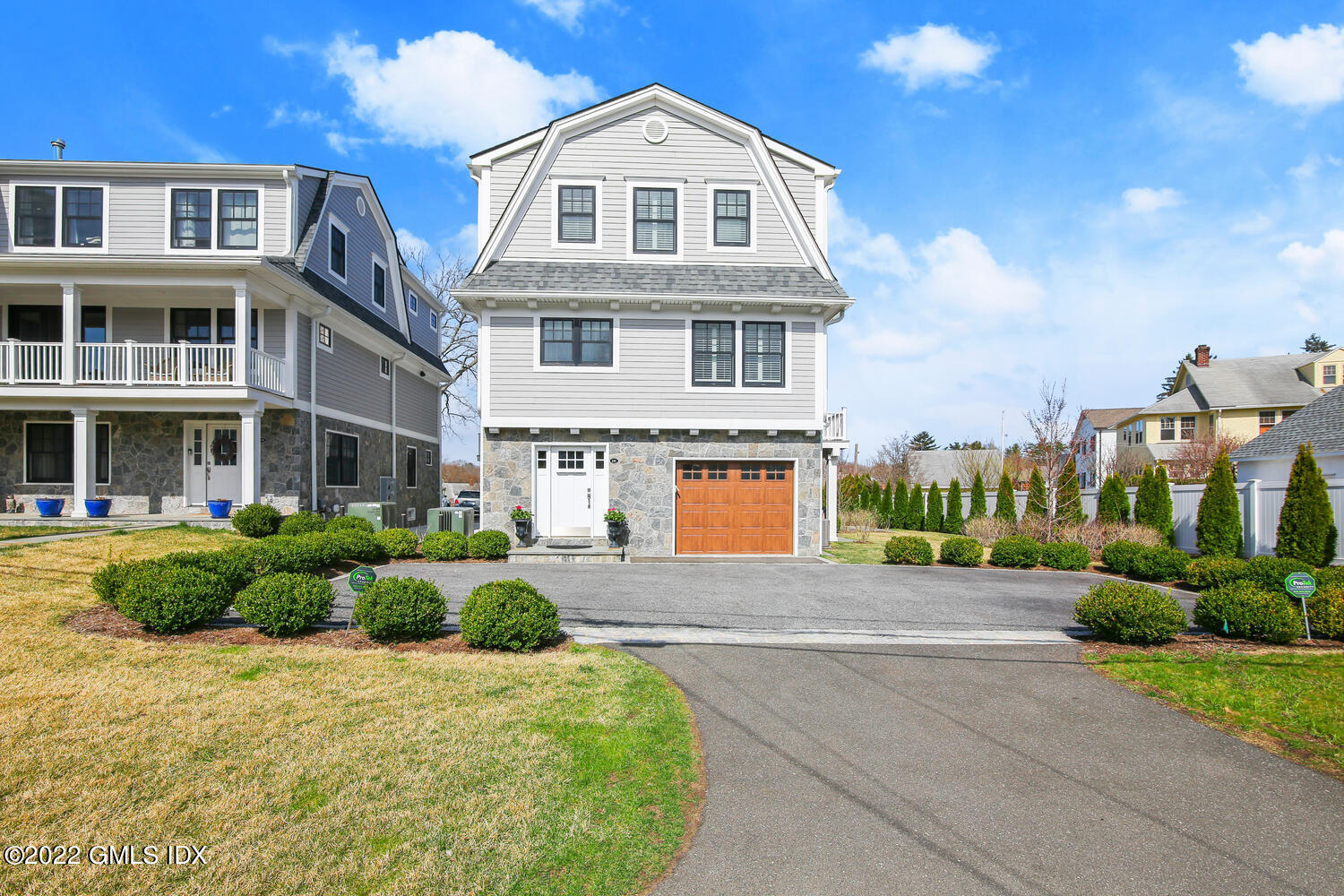 24 Harold Street, Unit C Cos Cob, CT 06807 - Photo 2 of 32 a front view of a house with a yard and garage