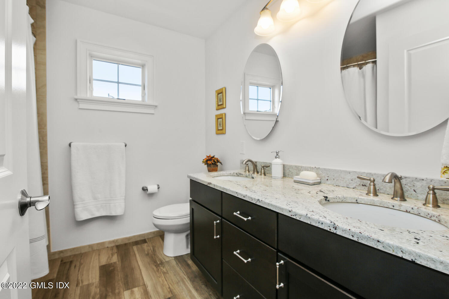 24 Harold Street, Unit C Cos Cob, CT 06807 - Photo 22 of 32 a spacious bathroom with a granite countertop double vanity sink a mirror and a toilet