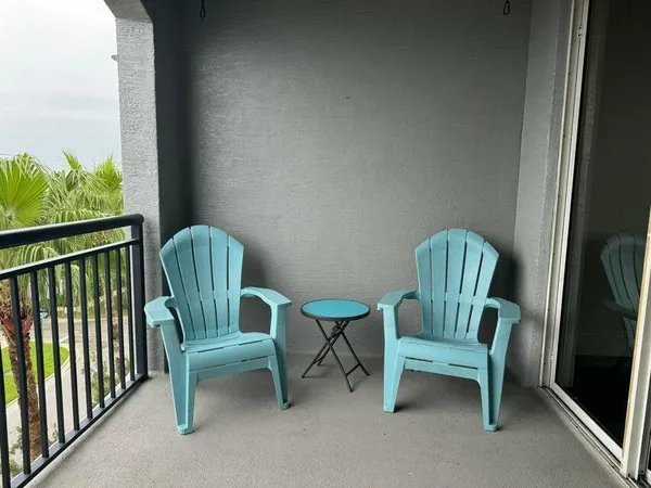 a view of a chair and fire pit in a balcony
