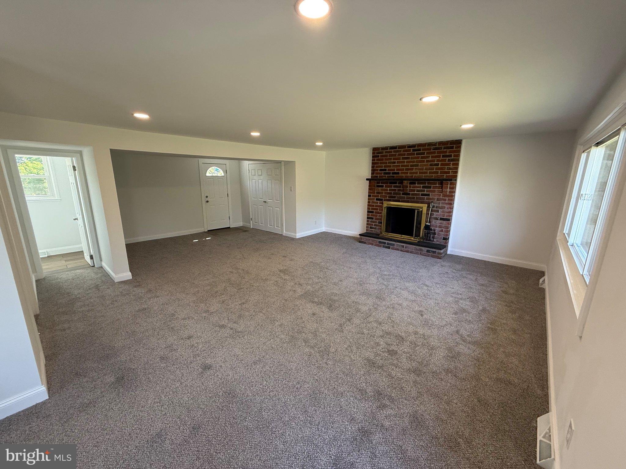 1104 Church Road Wyncote, PA 19095 - Photo 4 of 31 an empty room with fireplace and windows
