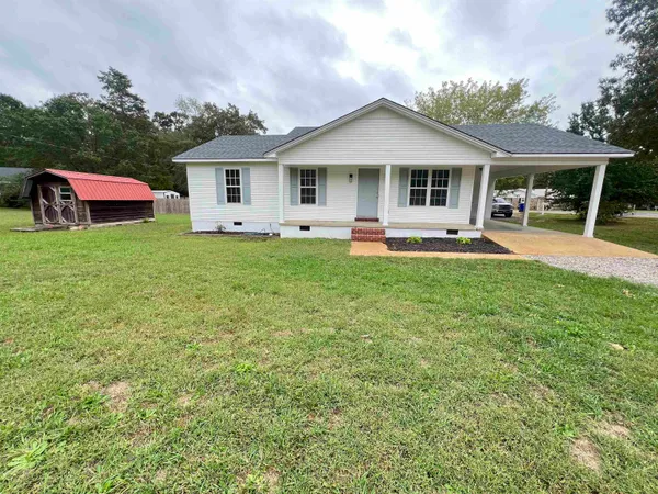 a front view of house with yard and outdoor seating
