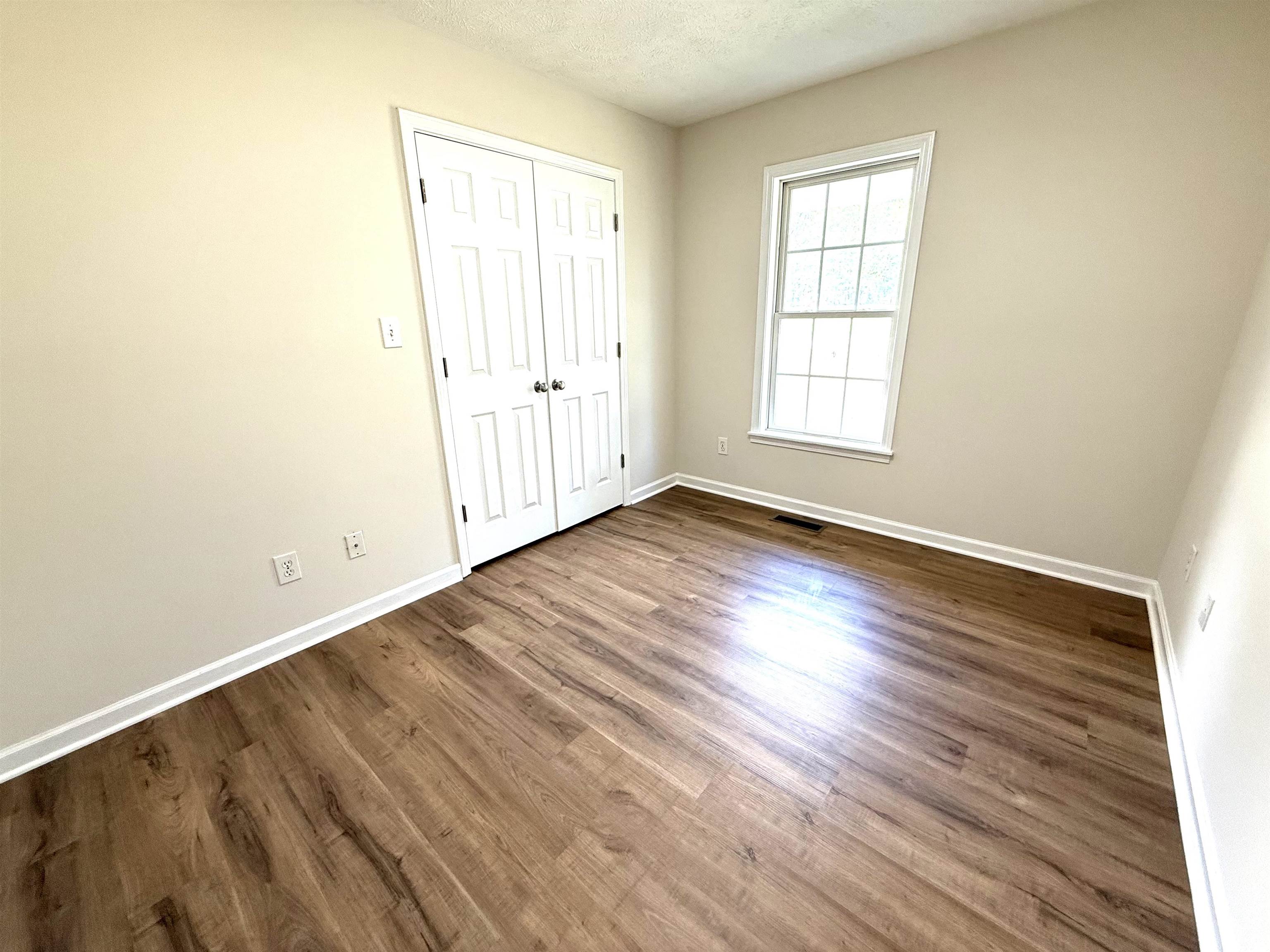 1250 Clifton Road Savannah, TN 38372 - Photo 14 of 33 Unfurnished bedroom featuring wood finished floors, a textured ceiling, and a closet