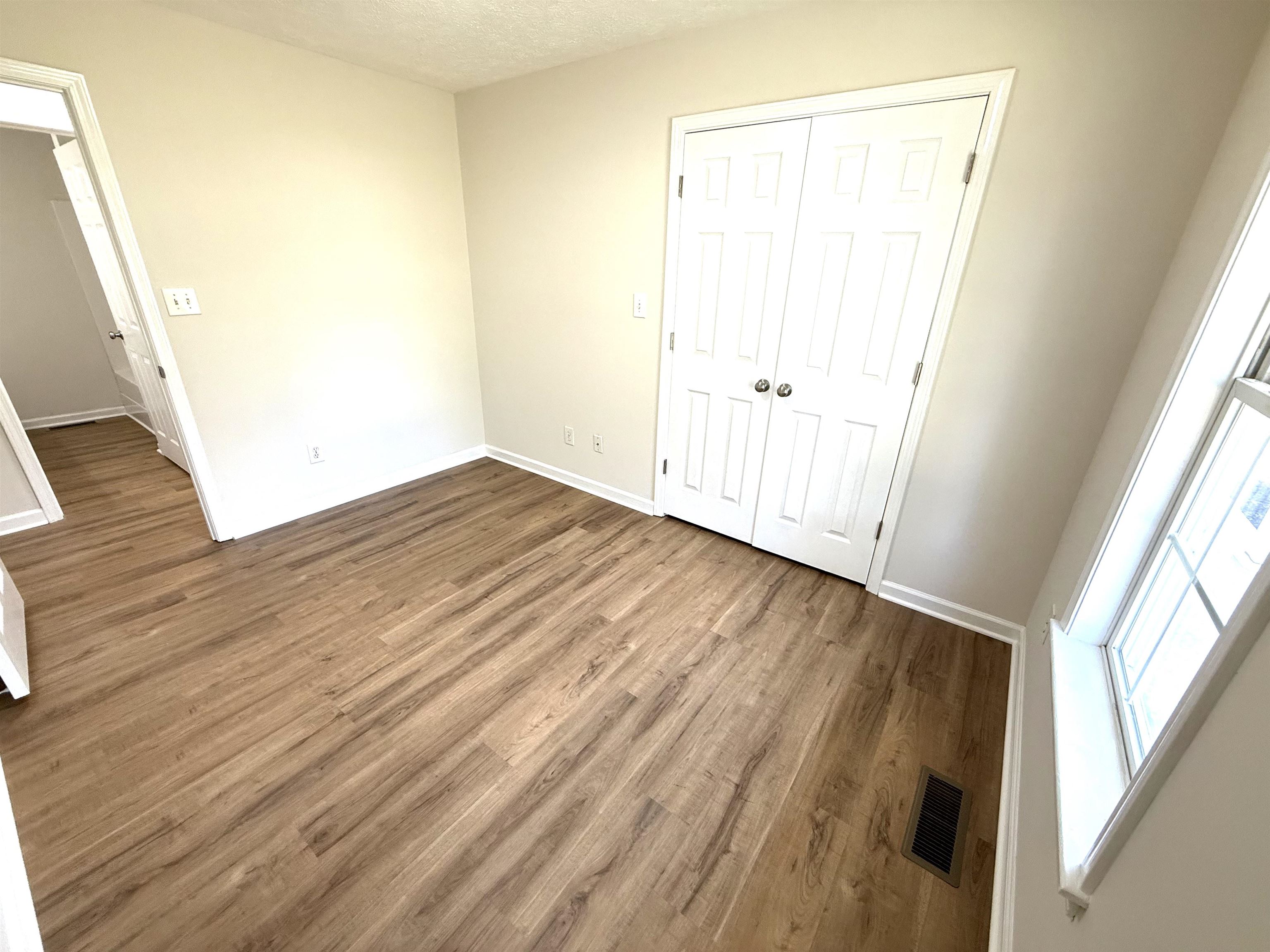 1250 Clifton Road Savannah, TN 38372 - Photo 15 of 33 Unfurnished bedroom with wood finished floors and a textured ceiling