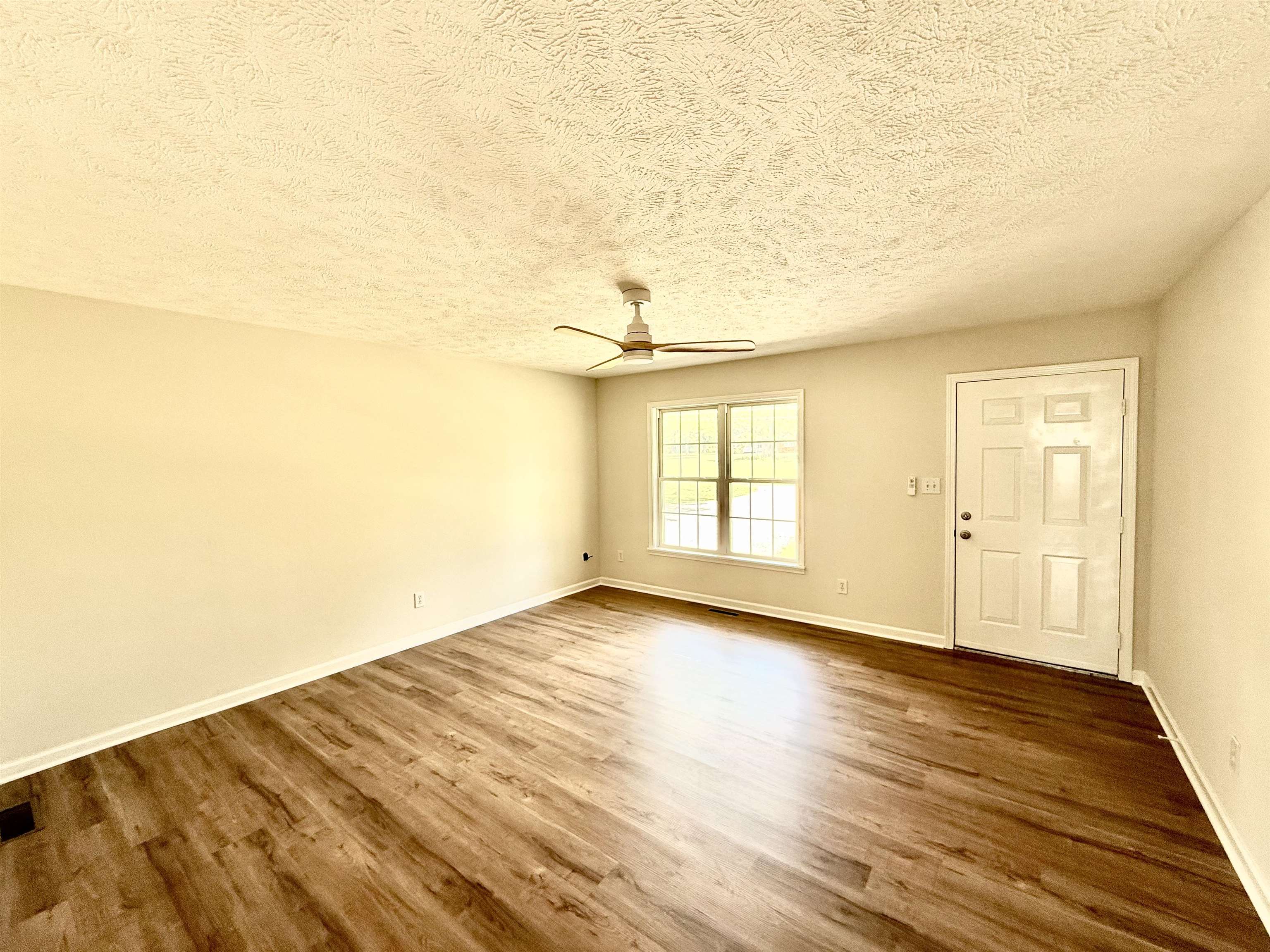 1250 Clifton Road Savannah, TN 38372 - Photo 7 of 33 Foyer entrance with a textured ceiling, wood finished floors, and ceiling fan
