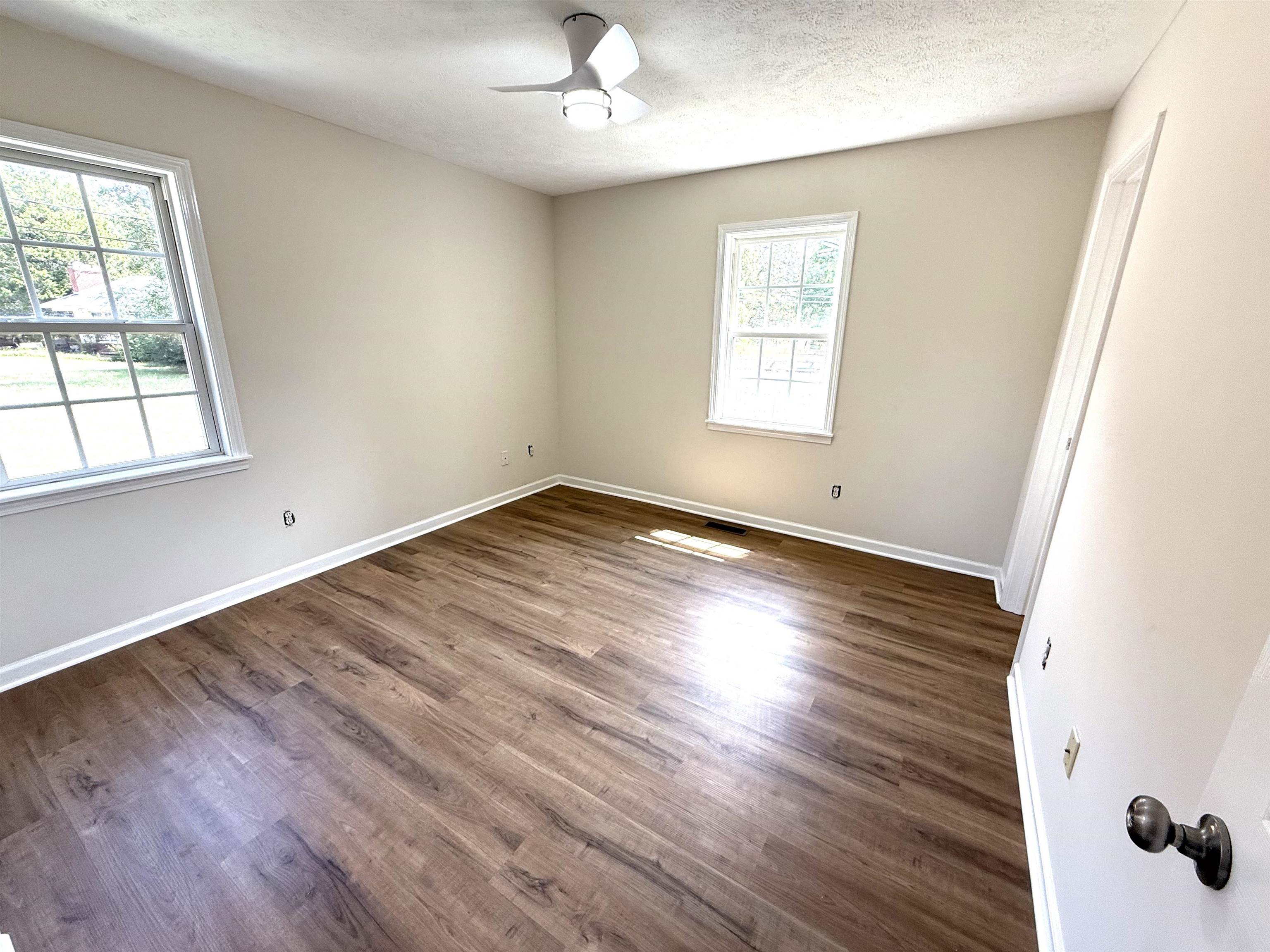1250 Clifton Road Savannah, TN 38372 - Photo 10 of 33 Unfurnished room featuring wood finished floors and a textured ceiling