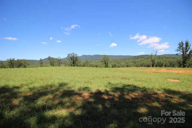 a view of a wooden fence and trees